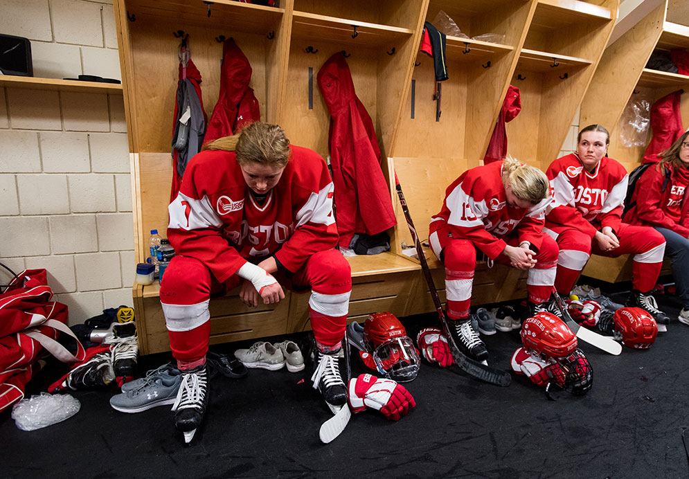 BU women's ice hockey players rest in the locker room in between periods.