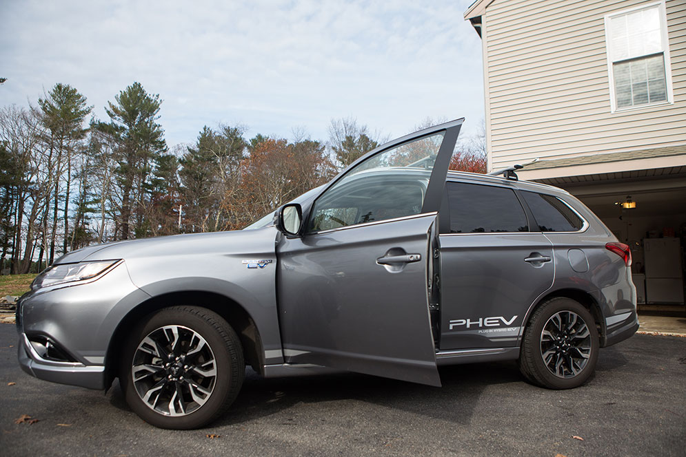 Side view of the Mitsubishi Outlander PHEV with driver door open.