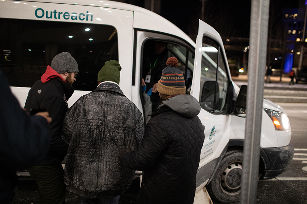 City of Boston volunteers help a homeless person into a van for transport to a shelter during the annual Boston Homeless Census.