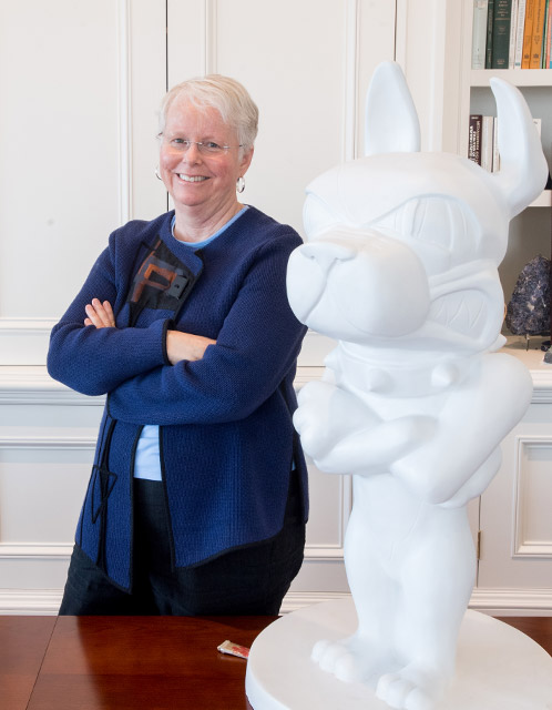 Portrait of Jean Morrison, Boston University Provost and Chief Academic Officer, in her office with a sculpture of BU mascot Rhett