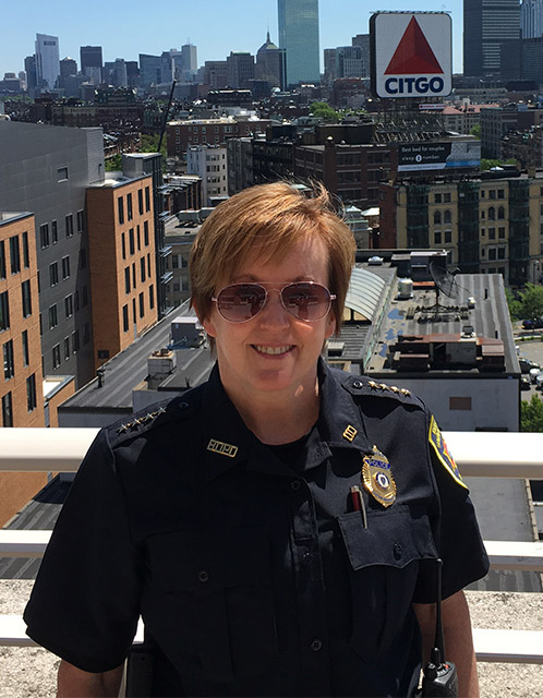 Portrait of Kelly Nee, Chief of police for the BU Police Department, on a rooftop overlooking Kenmore Sq.