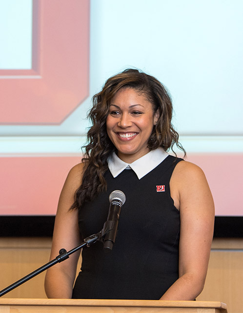 BU Terriers women's basketball head coach Marisa Moseley smiles at the podium during a press conference announcing her appointment as head coach of the team.