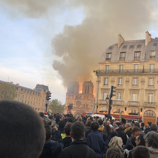 Photo of the Notre Dame Cathedral in Paris France showing the roof and spire on fire, April 15, 2019.