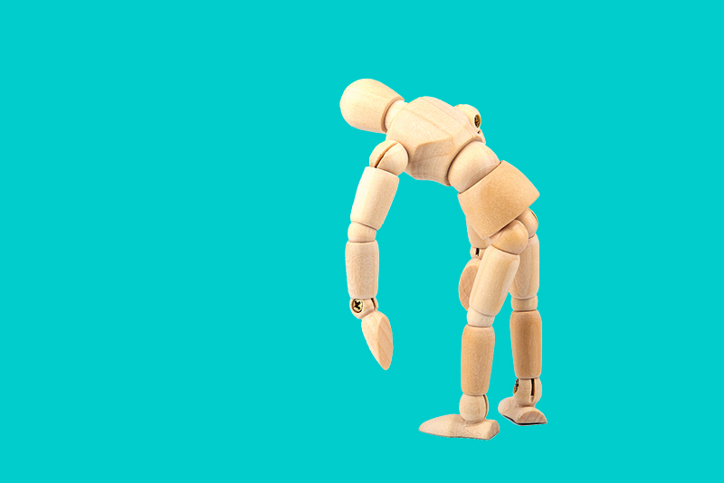 Frozen Shoulder concept photo showing a wooden marionette with limp arm.