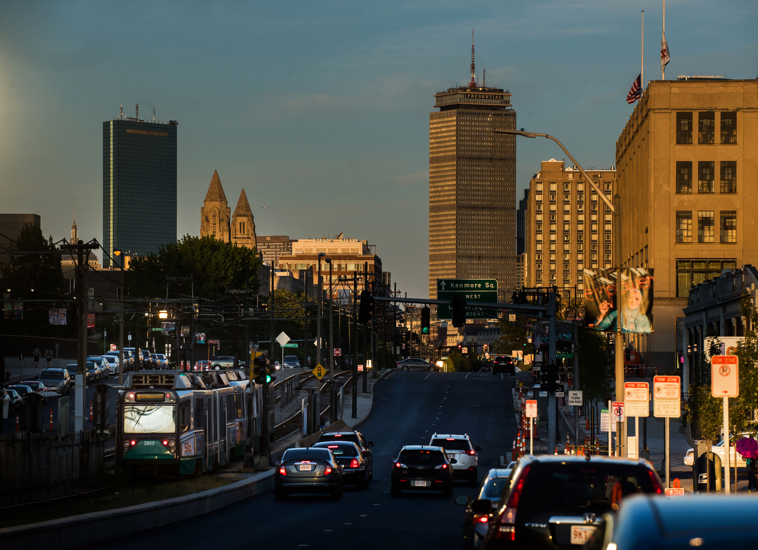View down Commonwealth Ave looking towards downtown Boston at twilight.