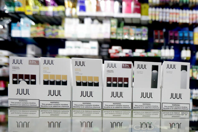 Packages of Juul e-cigarette products are seen on display at a smoke shop.