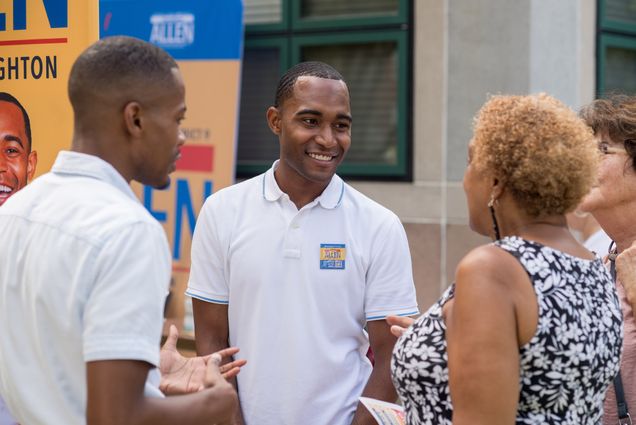 Jonathan Allen (LAW’19) campaigns at a community fair at a public housing complex in Brighton