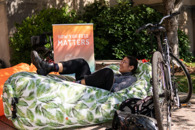 A student relaxes on an air hammock at the Sustainability Festival