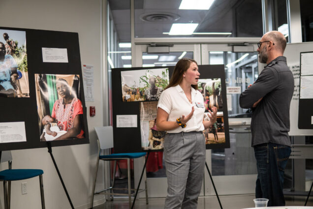Hailey Hart-Thompson talks with Paul Lipton at the opening reception for "The Role of the University in the Crisis of Forced Displacement: Ethics, Innovation, and Immersive Learning."