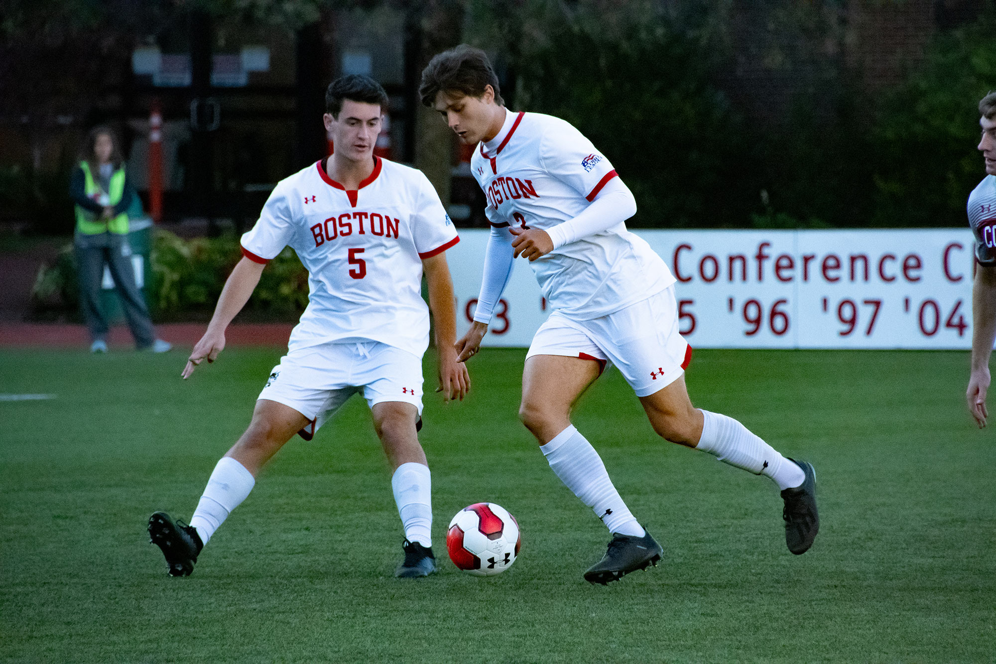 BU men's soccer players advance the ball during a game against Colgate University.