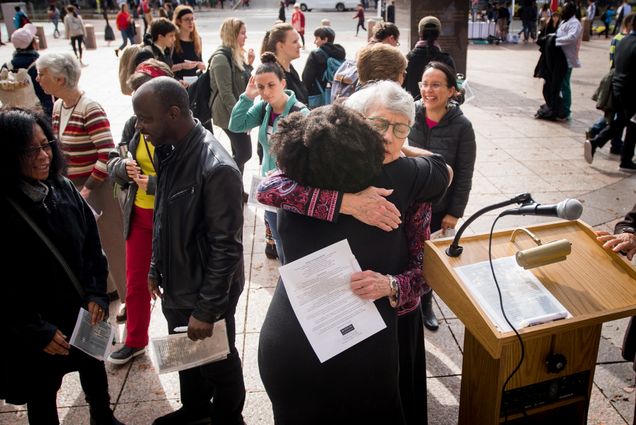 Two people embrace at the candle light vigil for black lives matter on marsh plaza