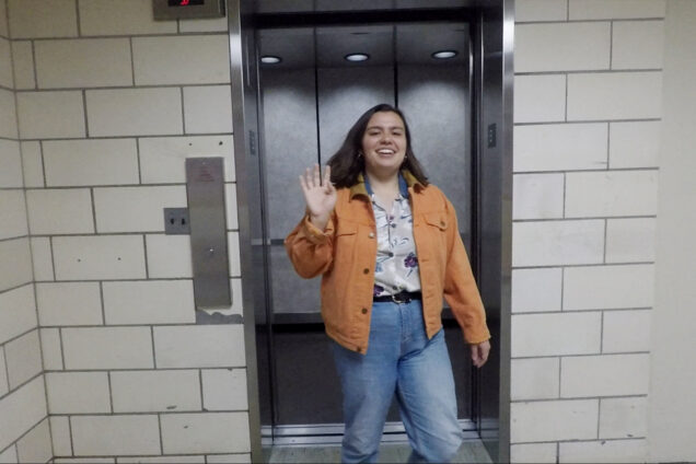 Temma Pelletier waves to the camera as she exits an elevator.