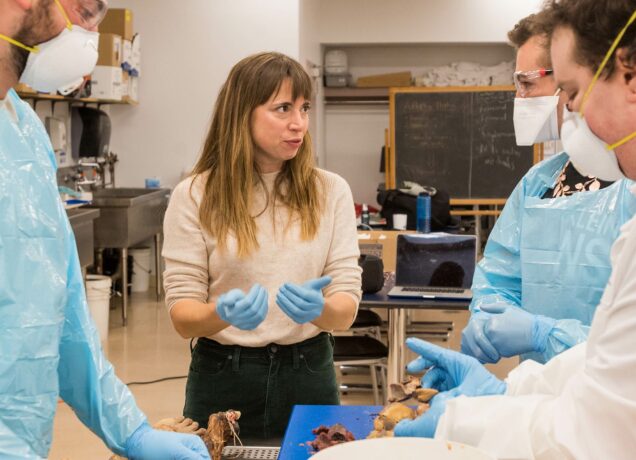 Professor Elizabeth Co talks to students in the Boston University Cadaver Lab advanced anatomy class.