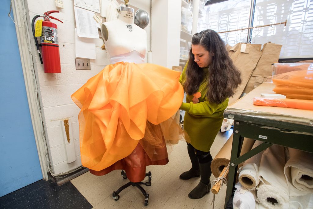  Kerl works on draping orange tulle to create a skirt