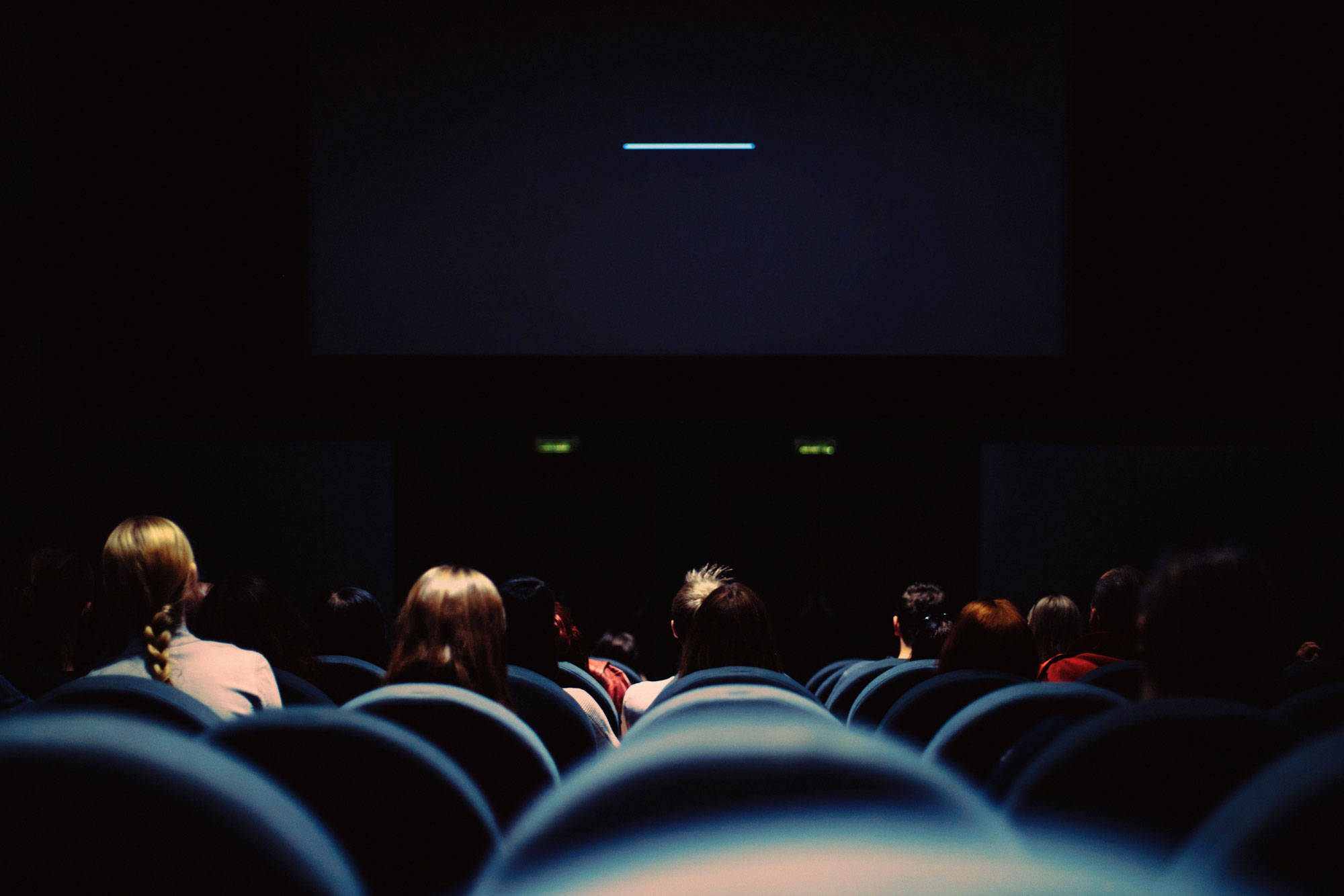 People sit in a movie theatre