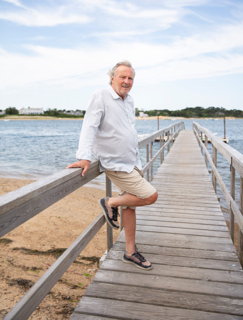 Jay M. Cashman poses for a portrait while standing on a pier.