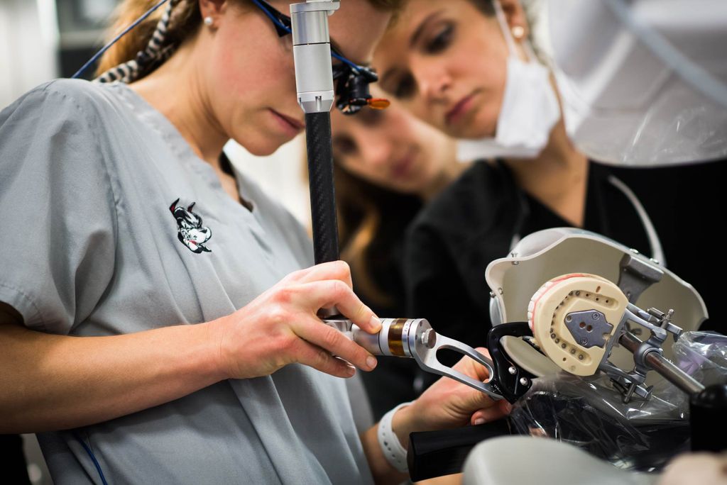 Dental students receiving training on Yomi, a robotic surgery assistant