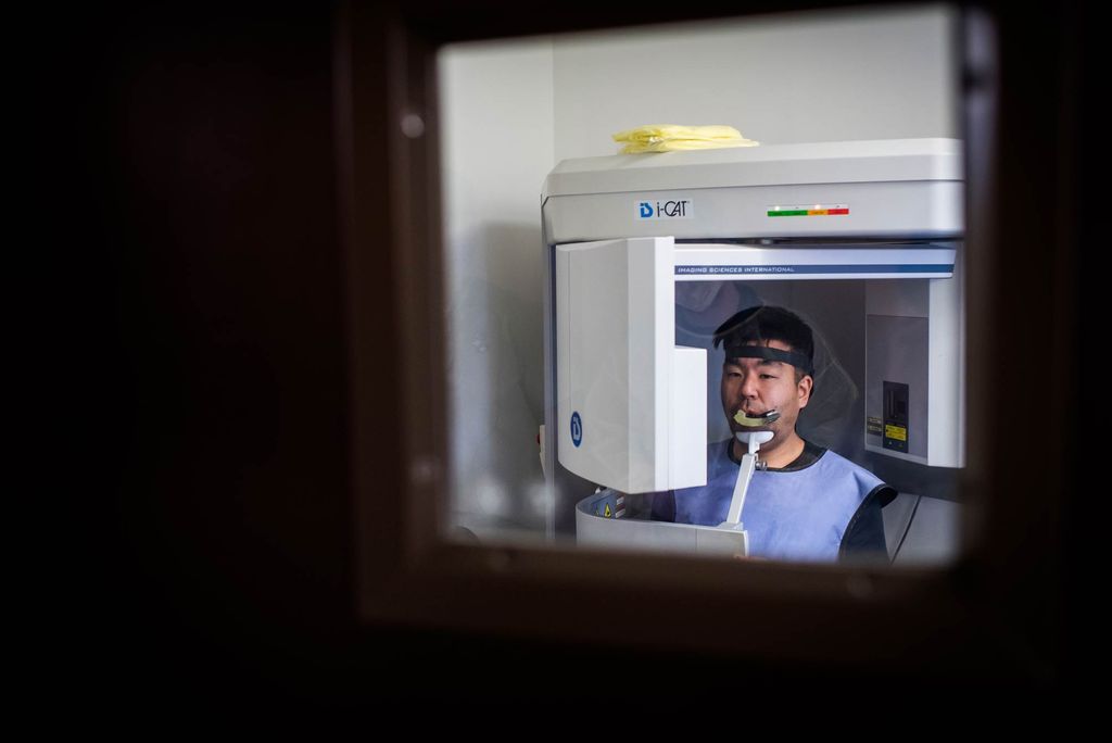 A dental scanner rotates around patients’ heads, creating 3D X-rays.