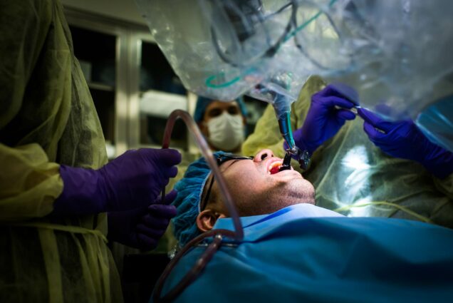 A robotic surgery assistant helps dentists do dental implants on a patient.