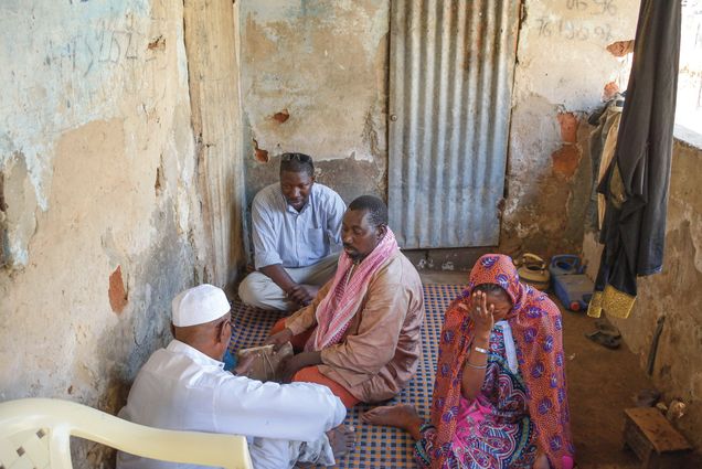 Fallou Ngom sits in the home of an Ajami manuscript owner in Belfort, Ziguinchor, Senegal.