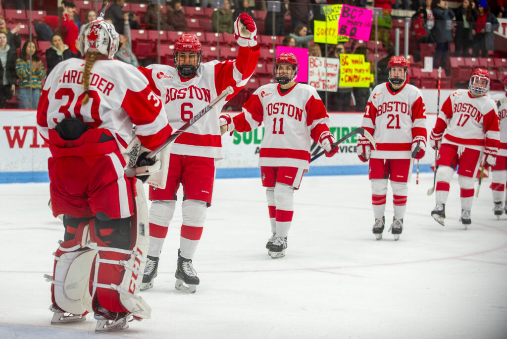 The BU women's hockey team celebrates after their Beanpot semifinal victory.