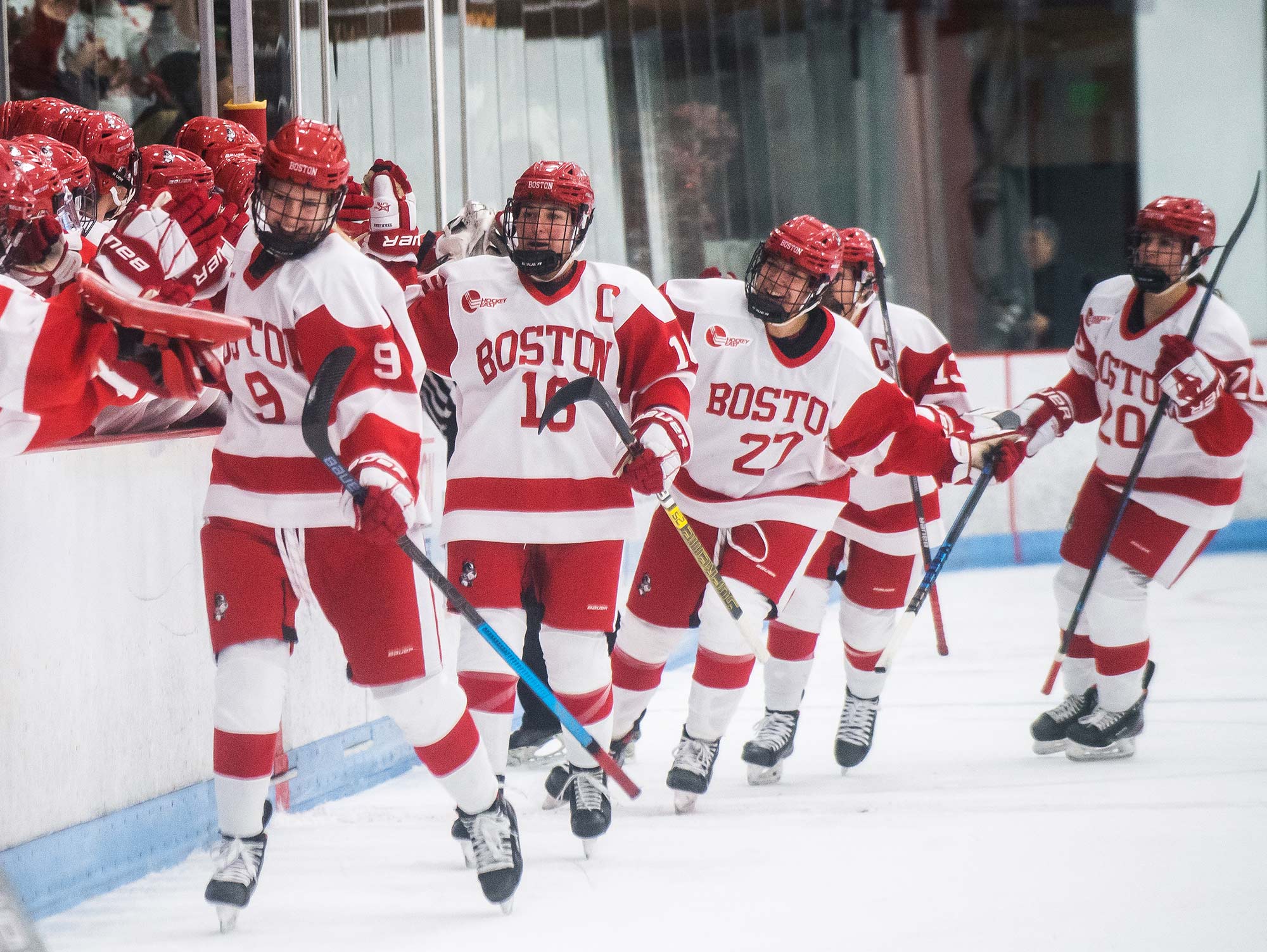 Members of BU's women's hockey team celebrate after scoring a goal in the first quarter against Boston College during the Women’s Beanpot tournament on Tuesday, February, 4, 2020