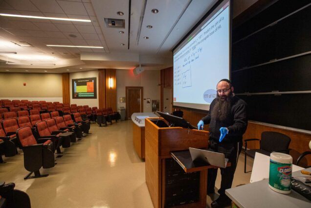 Senior Lecturer in Chemistry Binyomin Abrams gives a remote lecture using a laptop and his smart-podium at Boston University.