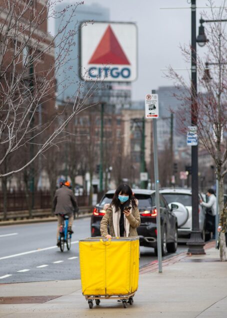 Photo of Warren Towers resident waiting for her ride to her new off campus housing on March 17, 2020. Boston's iconic Citgo sign can be seen in the background.