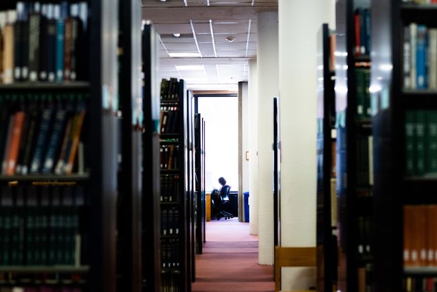 Photo of a student studying alone in Mugar Library on March 16, 2020.