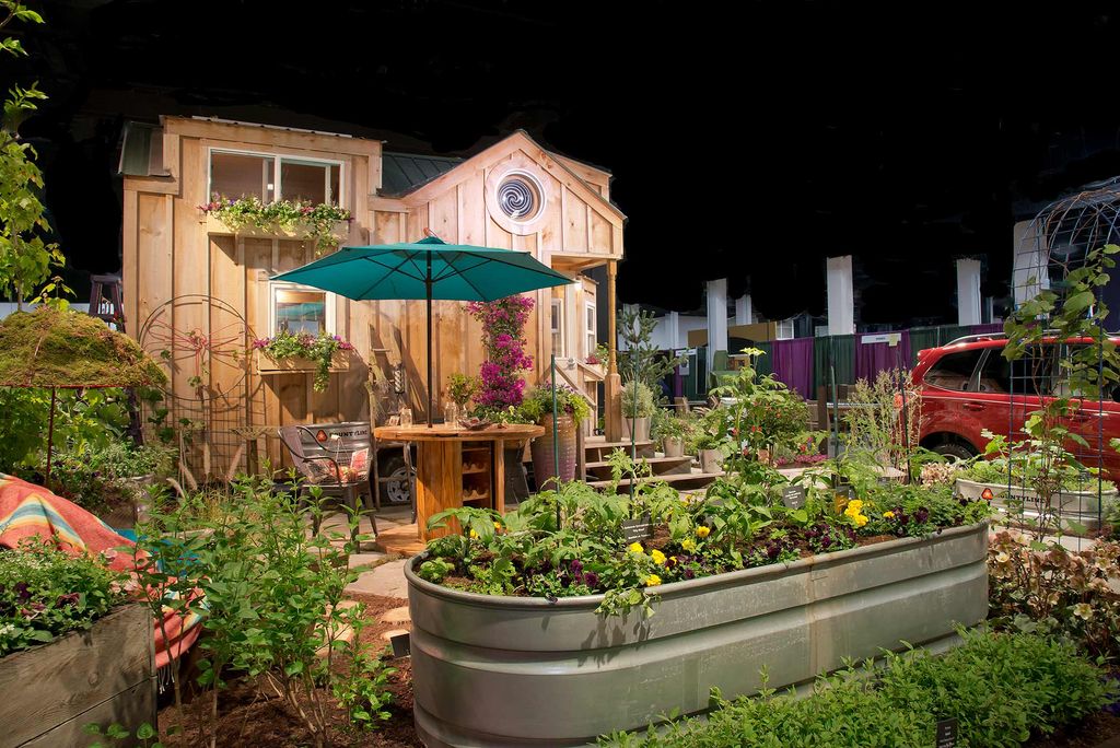 Image from Boston Flower and Garden Show at the Seaport World Trade Center showing flowers and painting on an easel