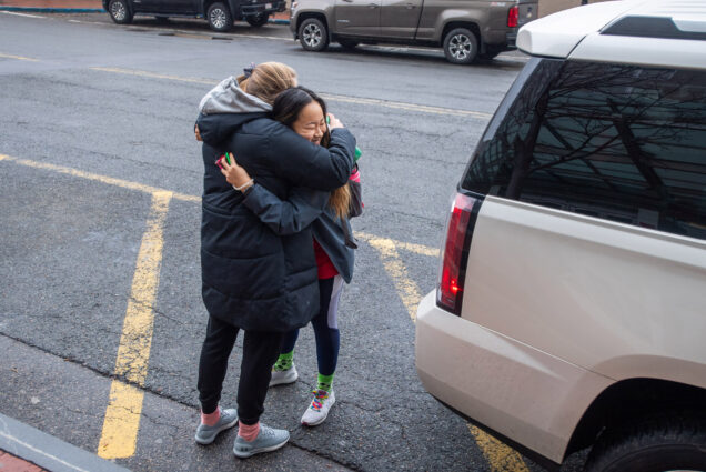 A photo of BU field hockey teammates Shannon Ma (right) and Rebecca Janes hugging goodbye last month as BU students left campus to flee the pandemic.