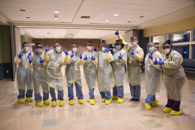 Members of the medical team at the Newton Pavilion COVID-19 recuperation unit for homeless patients, after putting on personal protective equipment for the unit’s opening on April 9, 2020.