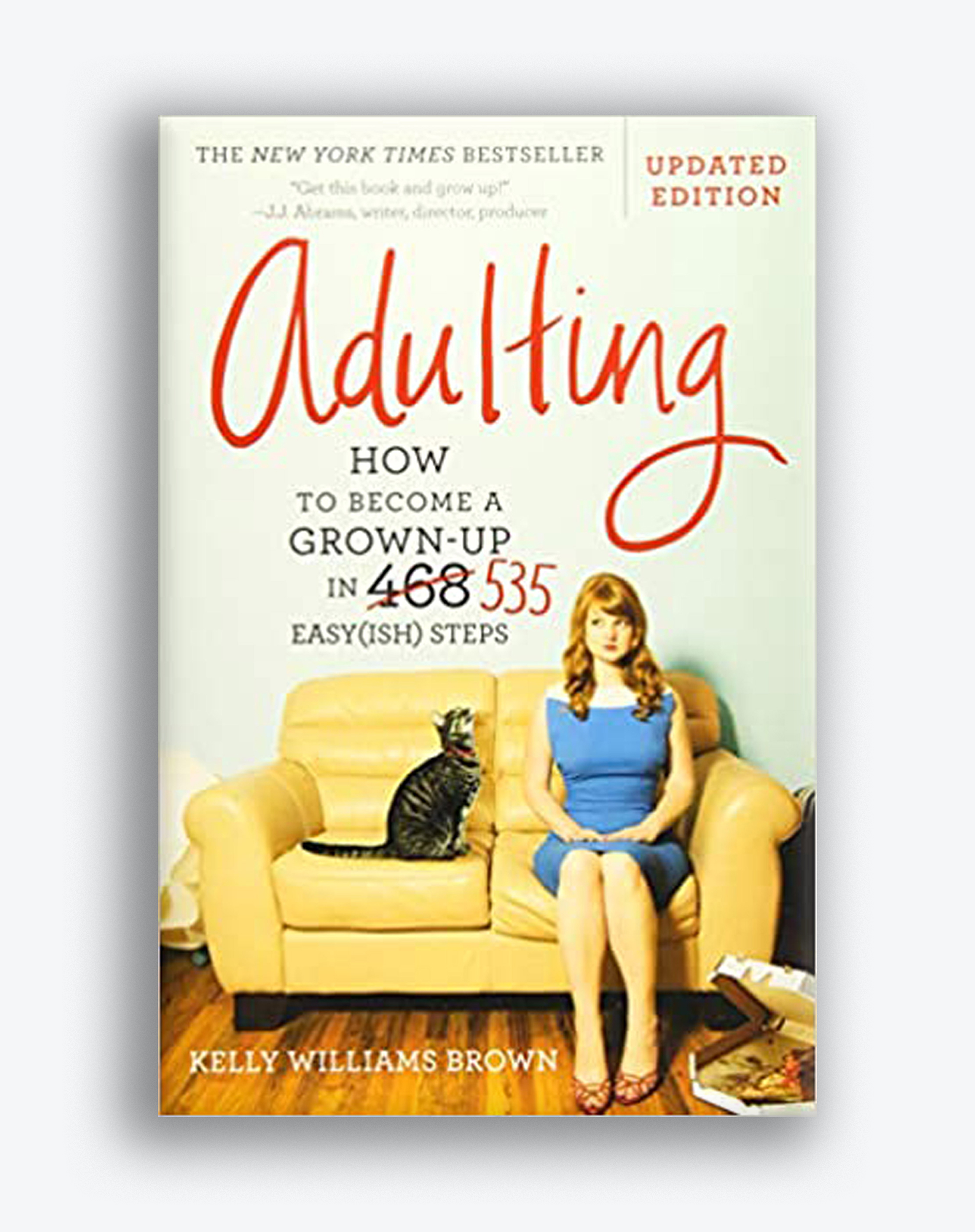 Book cover for "Adulting: How to Become a Grown-up in 535 Easy(ish) Steps" by Kelly Williams Brown. The cover depicts an illustration of a girl in a blue dress sitting on a couch next to a cat.