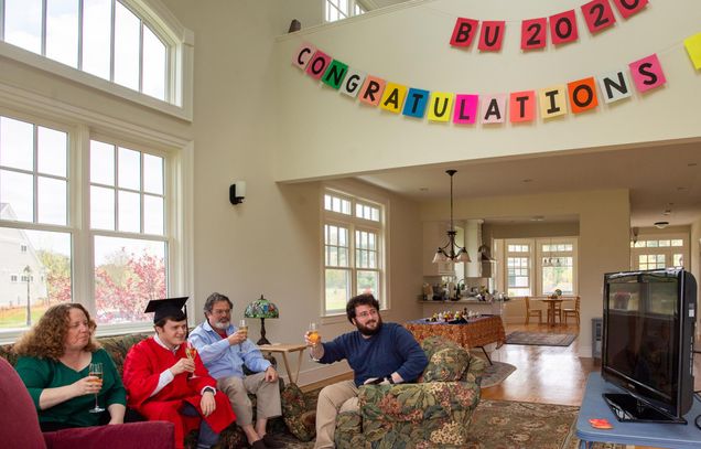  Jacob Gurvis (COM’20) sits with his family, including mom, Laura, left, dad Eric, third from left, and brother Aaron in their Sherborn home May 17 to watch the virtual toast presentation to the class of 2020. 