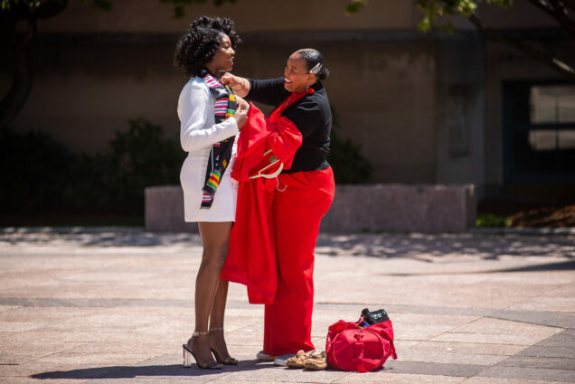 Ann-Lyssa Asare (Pardee’20) gets ready for her graduation photo shoot with the help of her mom Alisha Asare May 13, 2020. Her mom wears red trousers and Ann-Lyssa wears a white dress and heels.
