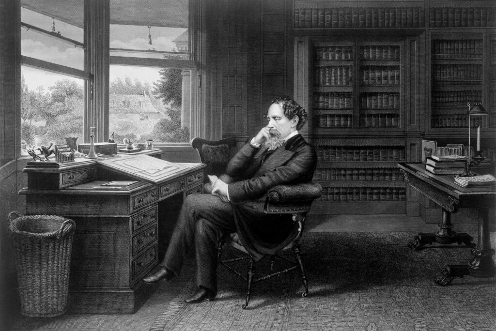 19th century engraving of Charles Dickens sitting in his study.