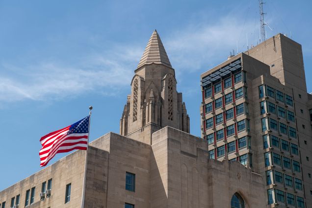 Stock image of Boston University campus on June 7, 2019. School of Law tower and the STH tower with the American flag flying.