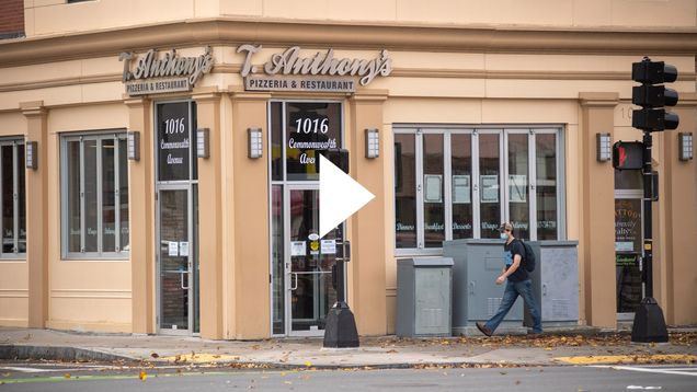 A photo of T Anthony's Pizza on Comm Ave. A white video play button is overlayed.