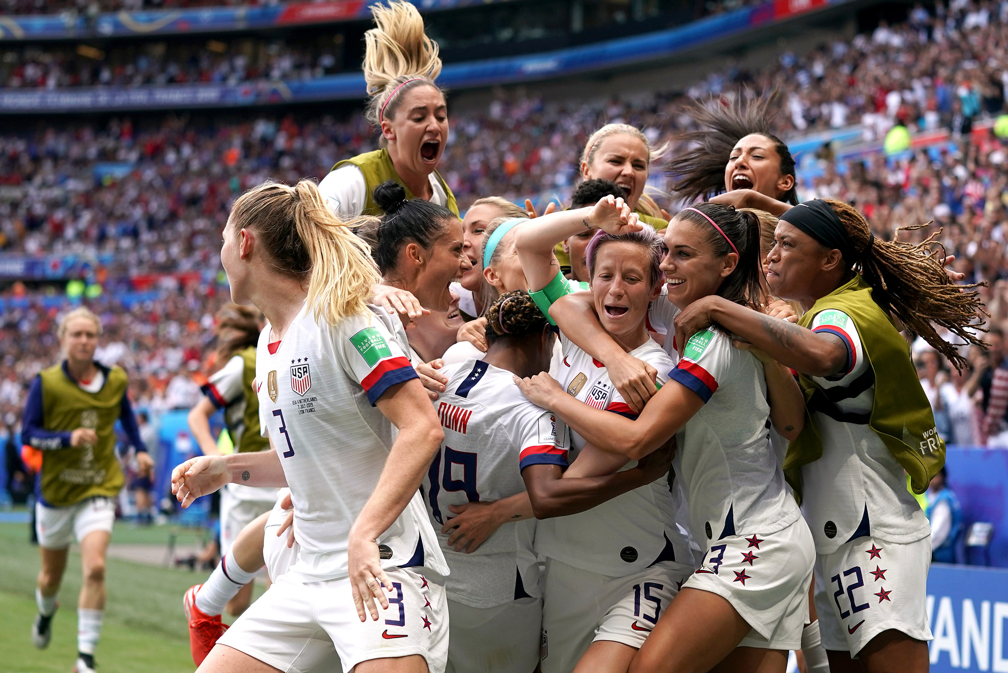 A photo of the US Women's National Soccer Team celebrating on the field