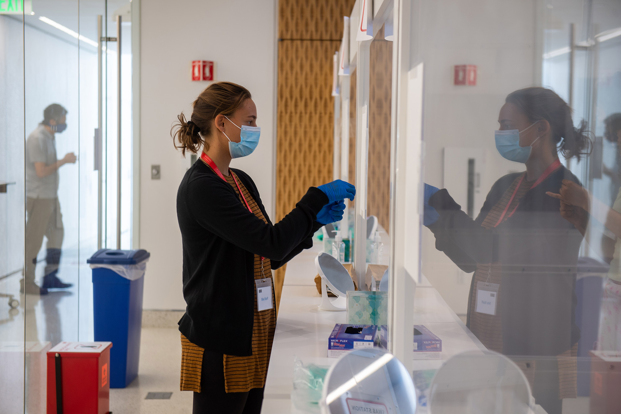 Collection site specialist Jessica Sandberg guides a visitor through the test collection process at the Rajen Kilachand Center August 25, 2020. According to the BU COVID-19 Testing Data Dashboard there have been 14965 tests administered as of August 23, 25 of which are positive.