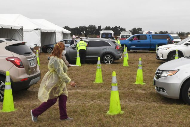 eople in cars line up to receive the Moderna COVID-19 vaccine from healthcare workers at a drive-thru site on January 13, 2021 in The Villages, Florida.