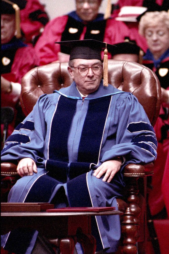 Photo of the Inauguration of Jon Westling as the President of Boston University in October 1996. He sits in a large, leather chair in light blue and dark blue regalia.