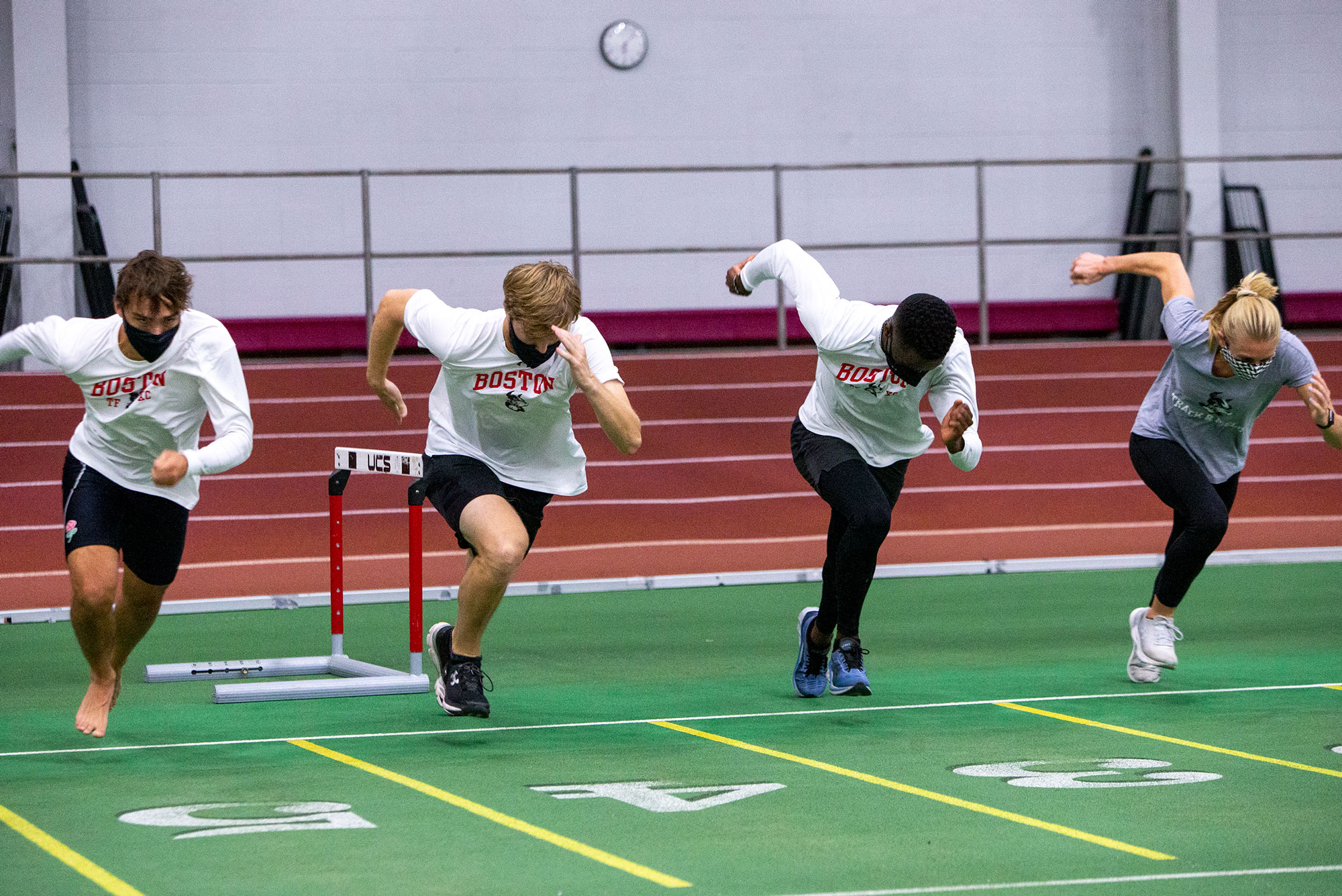 Four Terriers line up ready to run at a Track and Field practice