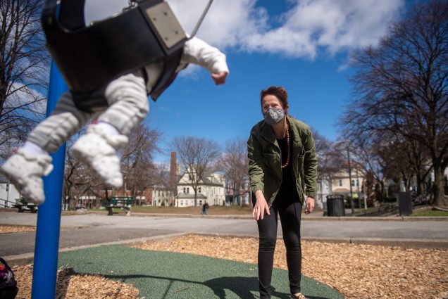 Bevin O'Gara pushes her son Henry on a swing at a park near their home in Jamaica Plain