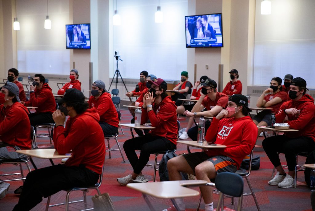 Members of the BU men's ice hockey team wait to see if they make the NCAA tournament