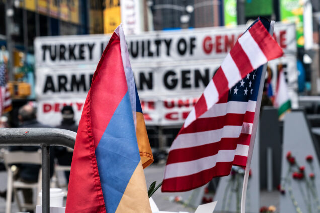 A photo of the Armenian and American flags at a rally commemorating the anniversary of the Armenian genocide