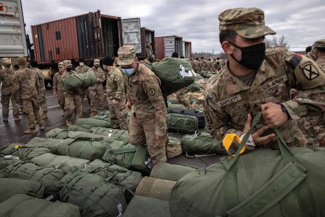US Army soldiers of the 10th Mountain Division pick up their duffel bags after arriving home from a 9 month deployment in Afghanistan.