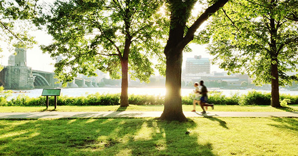 Two runners jogging along the Boston Esplanade