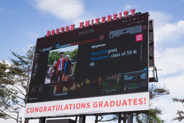 A photo of the jumbotron at Nickerson Field showing well wishes to graduates