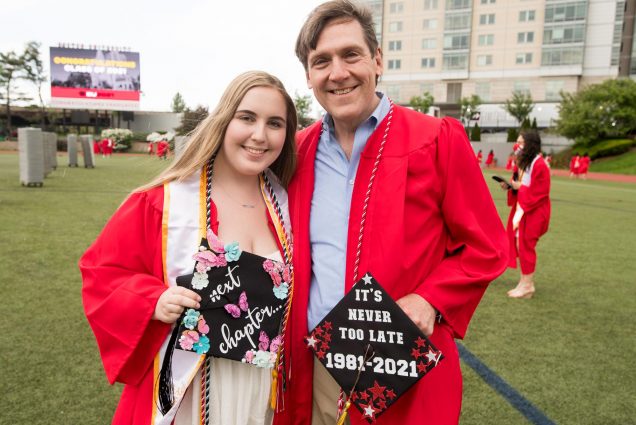 A photo of Rory Kallfelz (MET’21) and Alexandra Kallfelz (COM’21) on the field at commencement